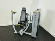 Matrix G7 Series Commercial Chest Press Machine with gray and black colors, featuring an adjustable seat and back pad, independent converging arm movements, and a foot platform.